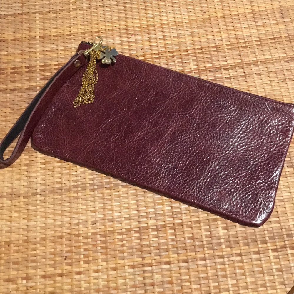 Brown Moss Mills clutch with clover charm.